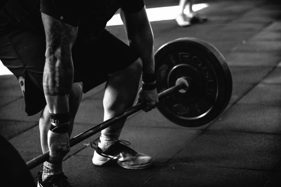 pexels-photo-791763-791763-1 A powerful black and white image of a man deadlifting in a gym, showcasing strength and fitness.